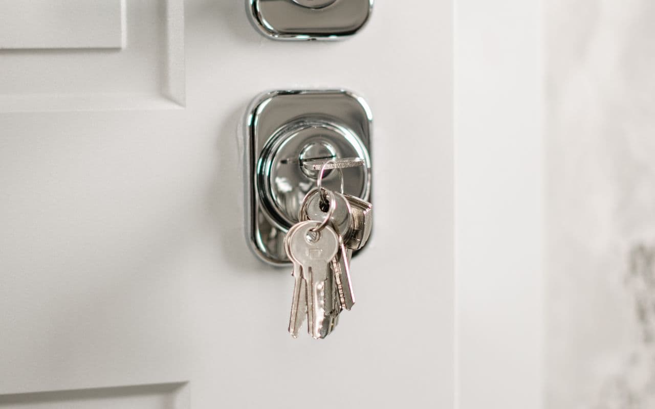 Chrome deadbolt lock and keys on a Cyprus holiday-home front door