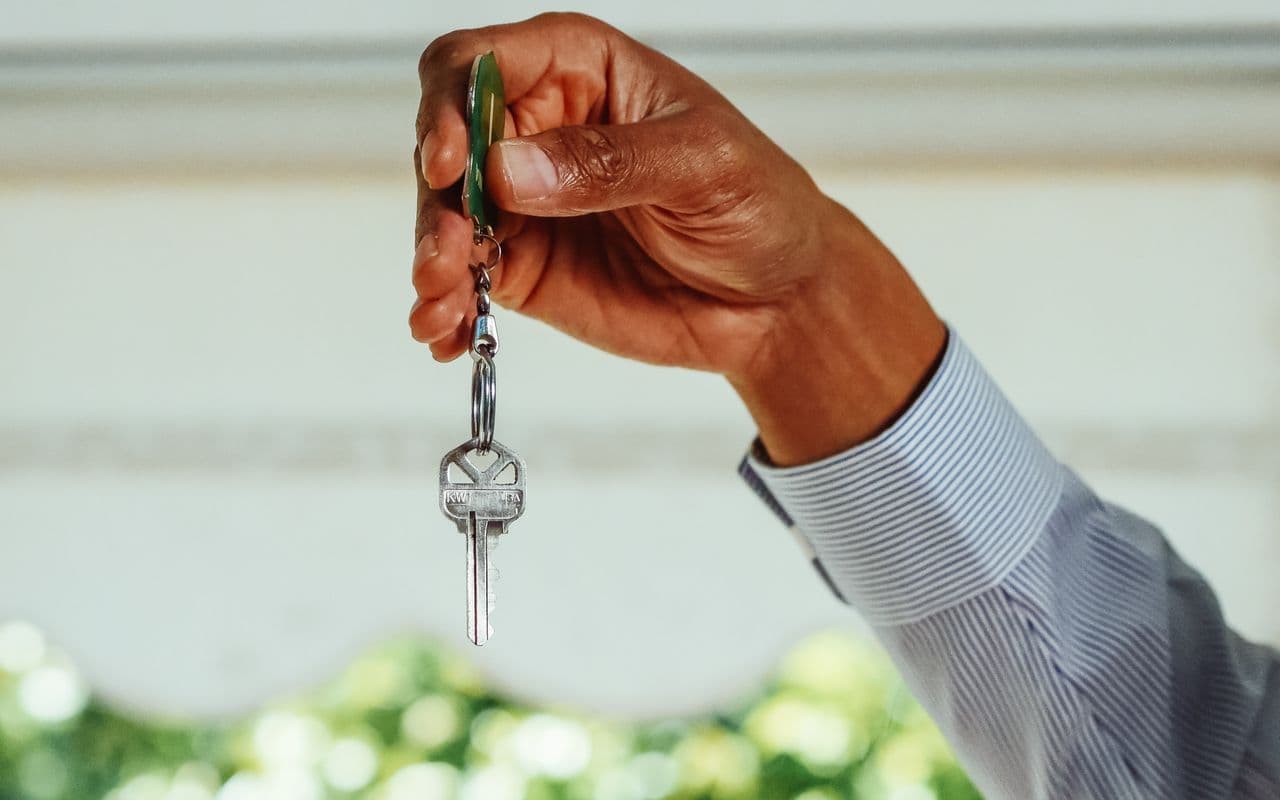 Hand holding a house key for keyholding and property management in Paphos
