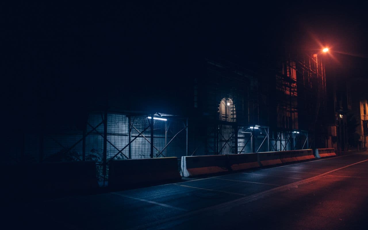 Dark residential street in Cyprus at night under security watch
