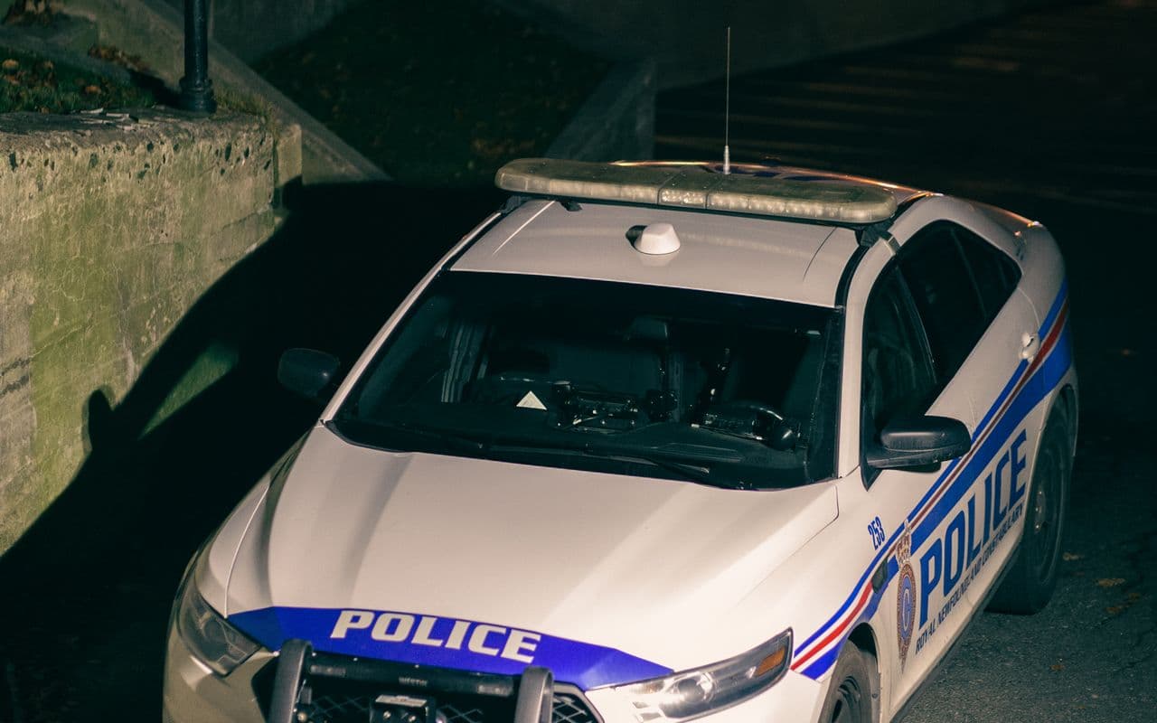 Marked 247 Security patrol vehicle with light-bar responding at night in Paphos
