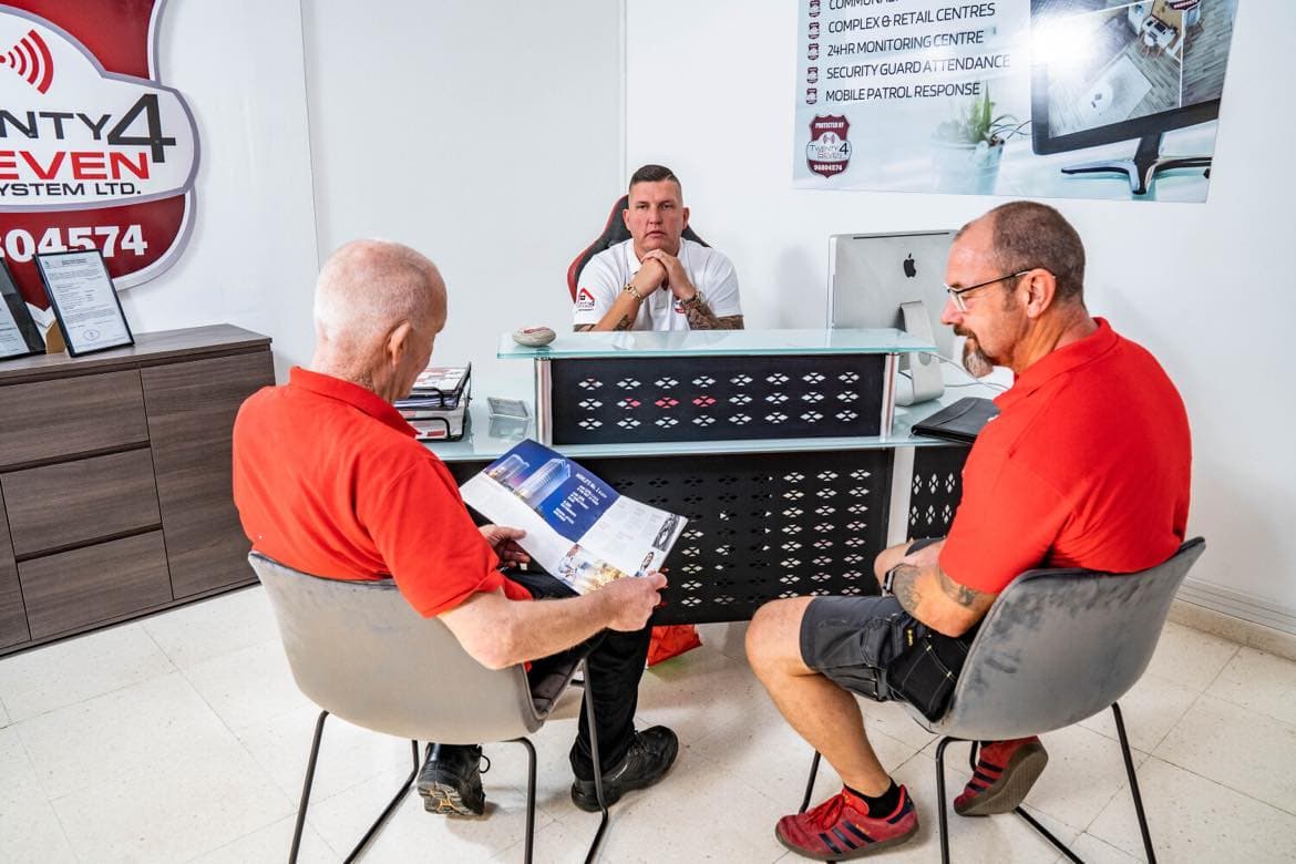 Two Twenty4Seven engineers going through a security proposal with a colleague at the Paphos office