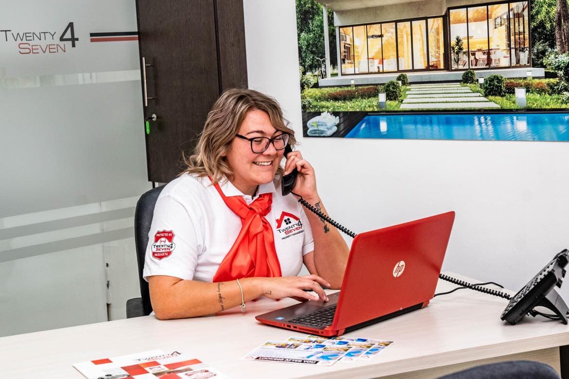 Jade on the phone at her desk in the Twenty4Seven property management office
